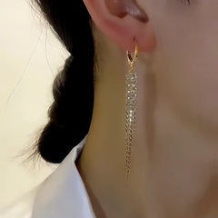 Model showcasing the dangle and style of the 14K Gold-plated Diamond Tassel Earrings