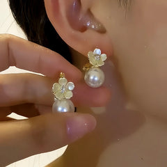Model showcasing the dangle and style of the 14K Gold-plated Double-Sided Shell Flower Pearl Earrings