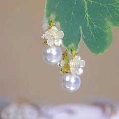 Angled view of the 14K Gold-plated Double-Sided Shell Flower Pearl Earrings