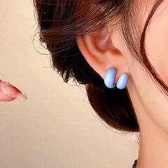 Model showcasing the dangle and style of the 14K Gold-plated Double C Earrings