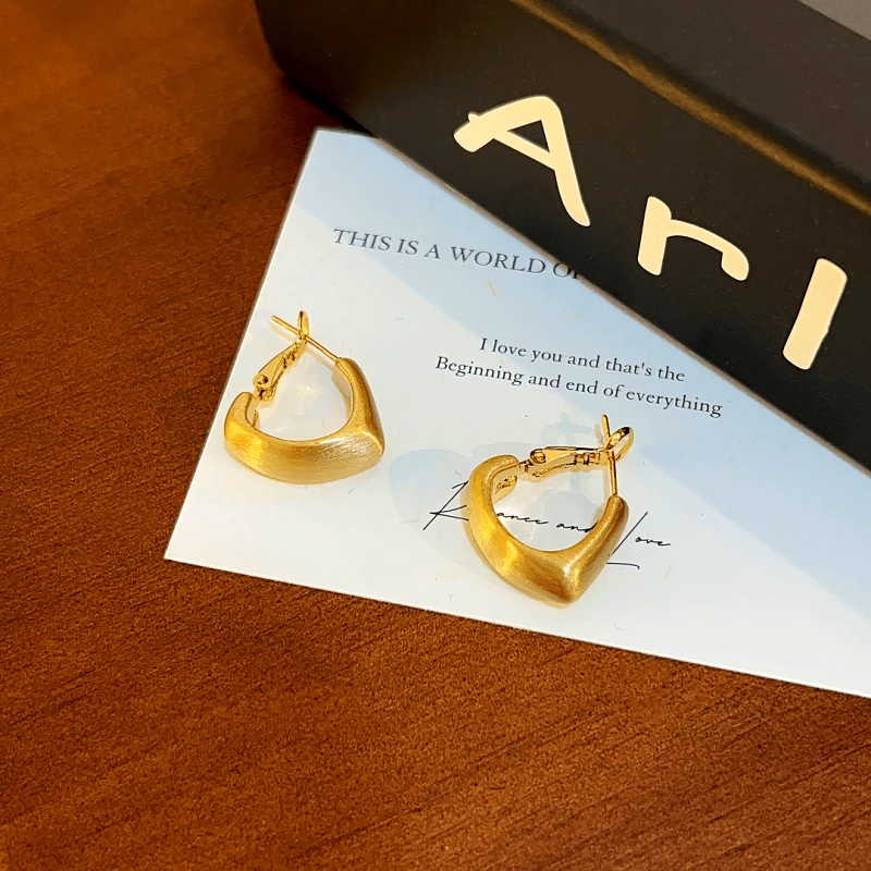 Angled view of the 14K Gold-plated Elegant Brushed Heart-Design Earrings