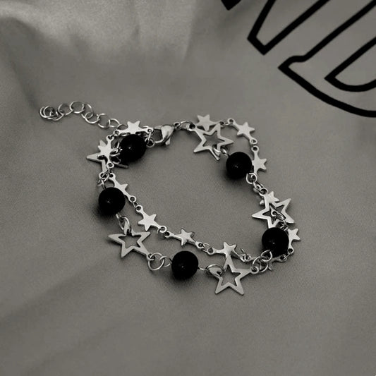 Model wearing the 14K Gold-plated Exquisite Hollow Five-Pointed Star Clavicle Bracelet to highlight its design on the wrist