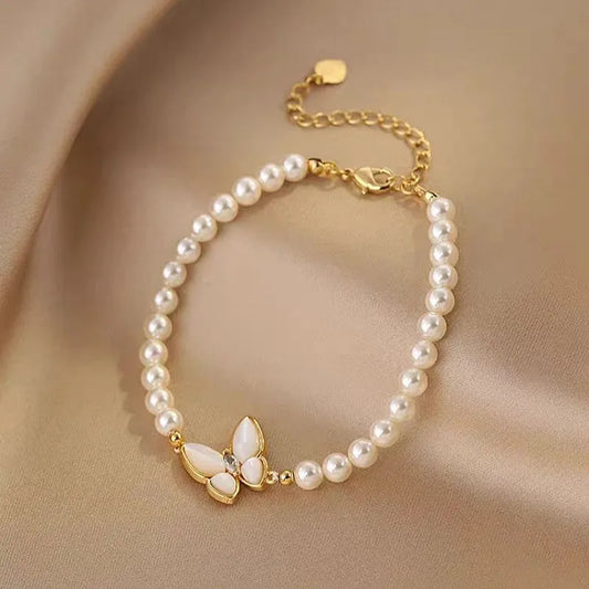 Model wearing the 14K Gold-plated Exquisite Pearl Butterfly Bracelets to highlight its design on the wrist