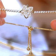 Model wearing the 14K Gold-plated Exquisite Zircon Flower Rotatable Bracelets to highlight its design on the wrist