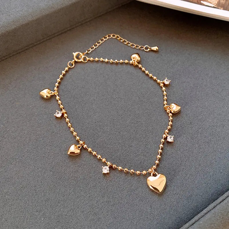 Model wearing the 14K Gold-plated Exquisite Zircon Heart Bracelets to highlight its design on the wrist