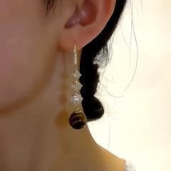 Close-up detail of the sparkling zircons and plating on the Pearl Threader Earrings