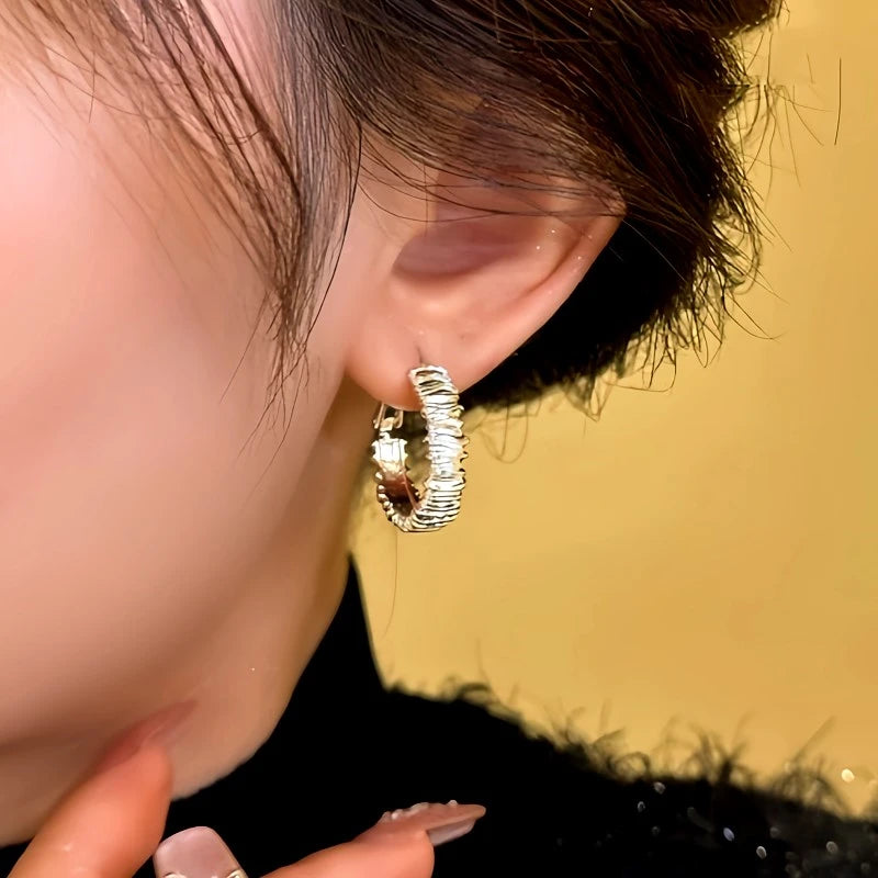 Model showcasing the dangle and style of the 14K Gold-plated Hoop Earrings