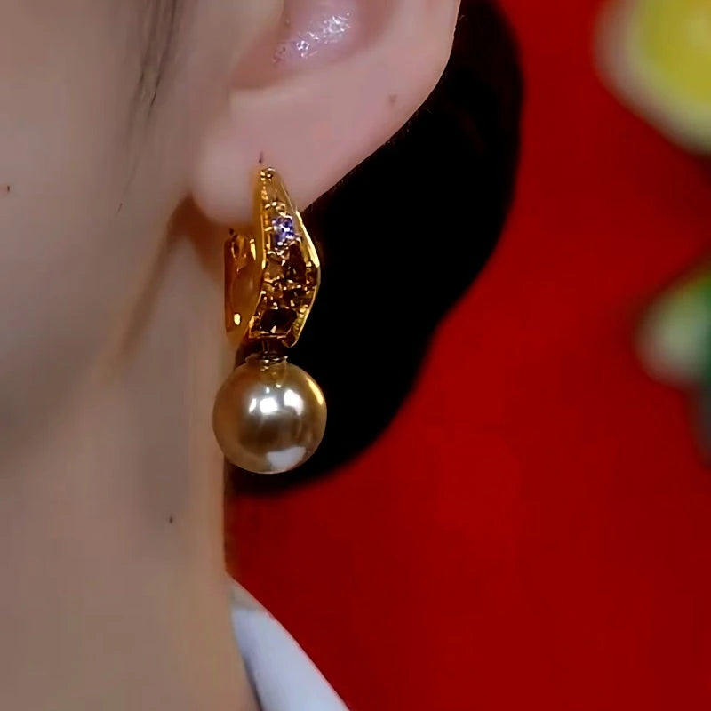 Model showcasing the dangle and style of the 14K Gold-plated Luxury Brown Diamond Pearl Earrings
