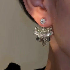 Model showcasing the dangle and style of the 14K Gold-plated Luxury Diamond Bead Tassel Earrings