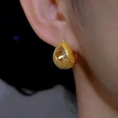 Model showcasing the dangle and style of the 14K Gold-plated Luxury Yellow Diamond Earrings
