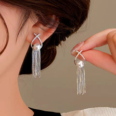 Model showcasing the dangle and style of the 14K Gold-plated Pearl Tassel Earrings