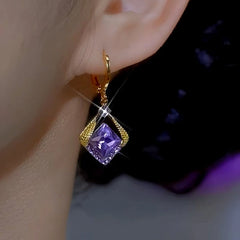 Gold purple square crystal drop dangle earring on ear, side close-up