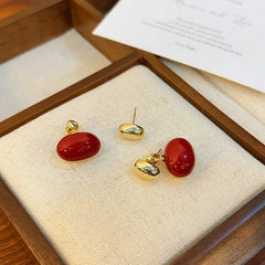 Angled view of the 14K Gold-plated Red Enamel Bean Earrings