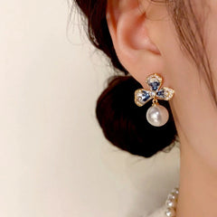 Close-up detail of the sparkling zircons and plating on the Flower Pearl Earrings