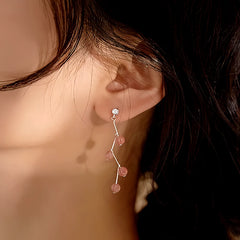 Model showcasing the dangle and style of the 14K Gold-plated Strawberry Crystal Earrings