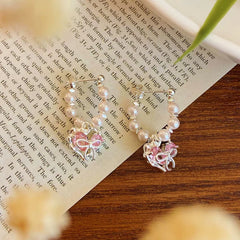Close-up detail of the sparkling zircons and plating on the Bow Heart Earrings