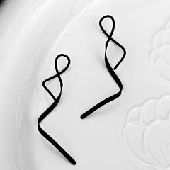Model showcasing the dangle and style of the 14K Gold-plated Wavy Threader Earrings