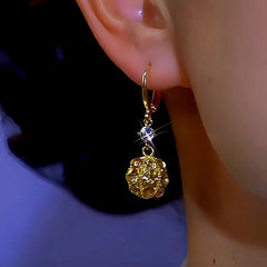 Model showcasing the dangle and style of the 14K Gold-plated Zircon Ball Earrings