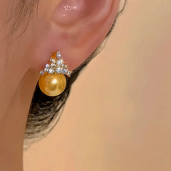 Model showcasing the dangle and style of the 14K Gold-plated Zircon Crown Stud Earrings