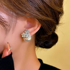 Model showcasing the dangle and style of the 14K Gold-plated Zircon Flower Jacket Earrings