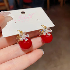 Angled view of the 14K Gold-plated Zircon Flower Pearl Earrings
