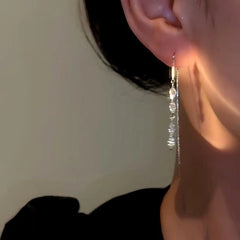 Close-up detail of the sparkling zircons and plating on the Tassel Earrings
