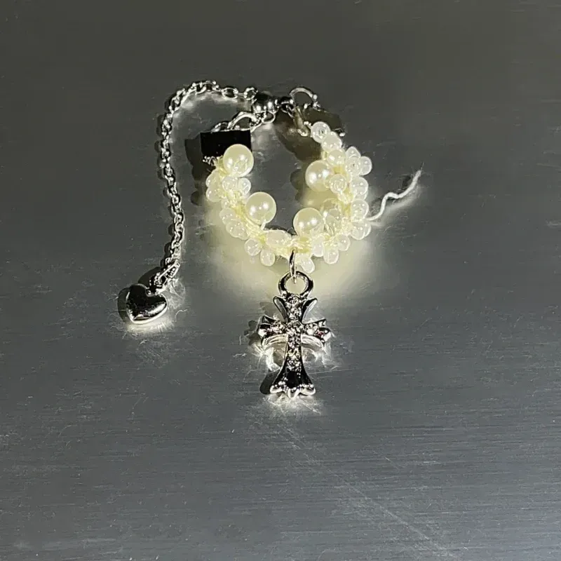 Close-up view of the gemstone and setting of the Gold Cross Ring