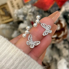 Angled view of the Zircon Butterfly Dangle Earrings | 14K Gold Plated