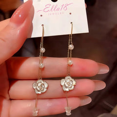 Model showcasing the dangle and style of the 14K Gold Plated Brown Camellia Threader Tassel Earrings