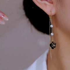 Angled view of the 14K Gold Plated Brown Camellia Threader Tassel Earrings