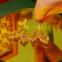 Close-up detail of the sparkling zircons and plating on the gold leaf earrings