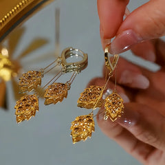 Angled view of the 14K Gold Plated Brown Zircon Wheat Tassel Earrings