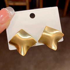 Close-up detail of the sparkling zircons and plating on the gold drop earrings