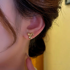 Model showcasing the dangle and style of the 14K Gold Plated Champagne Diamond Flower Stud Earrings