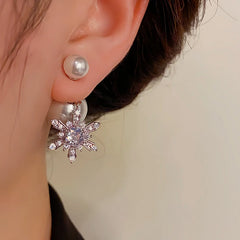 Close-up detail of the sparkling zircons and plating on the snowflake earrings