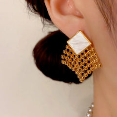 Model showcasing the dangle and style of the 14K Gold Plated Crystal Tassel Earrings