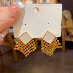 Angled view of the 14K Gold Plated Crystal Tassel Earrings