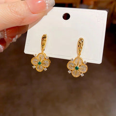 Close-up detail of the sparkling zircons and plating on the gold flower earrings