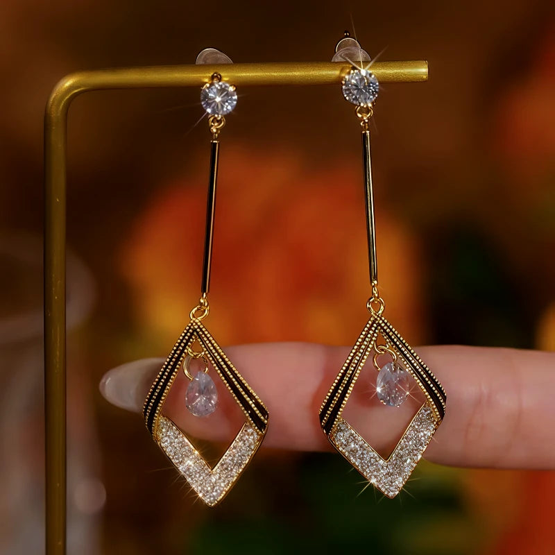 Close-up detail of the sparkling zircons and plating on the gold geometric earrings