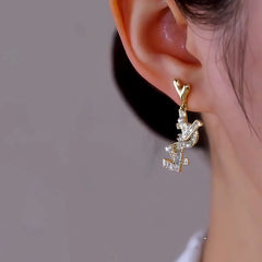 Close-up detail of the sparkling zircons and plating on the gold pearl earrings