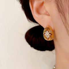 Close-up detail of the sparkling zircons and plating on the gold drop earrings