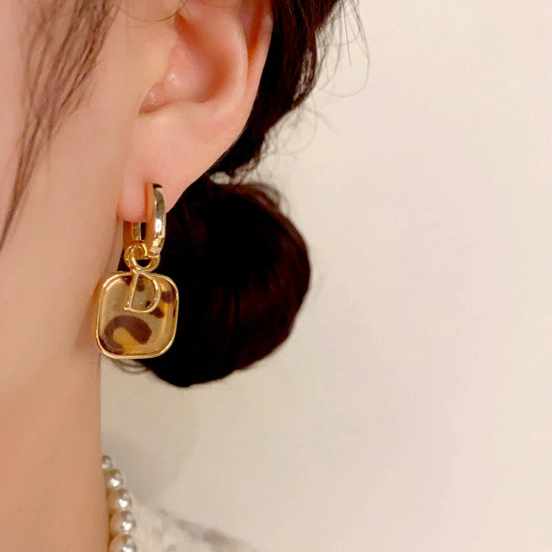 Close-up detail of the sparkling zircons and plating on the gold drop earrings