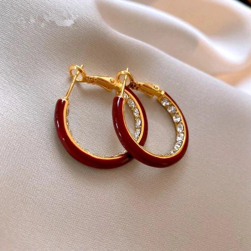 Close-up detail of the sparkling zircons and plating on the gold hoop earrings