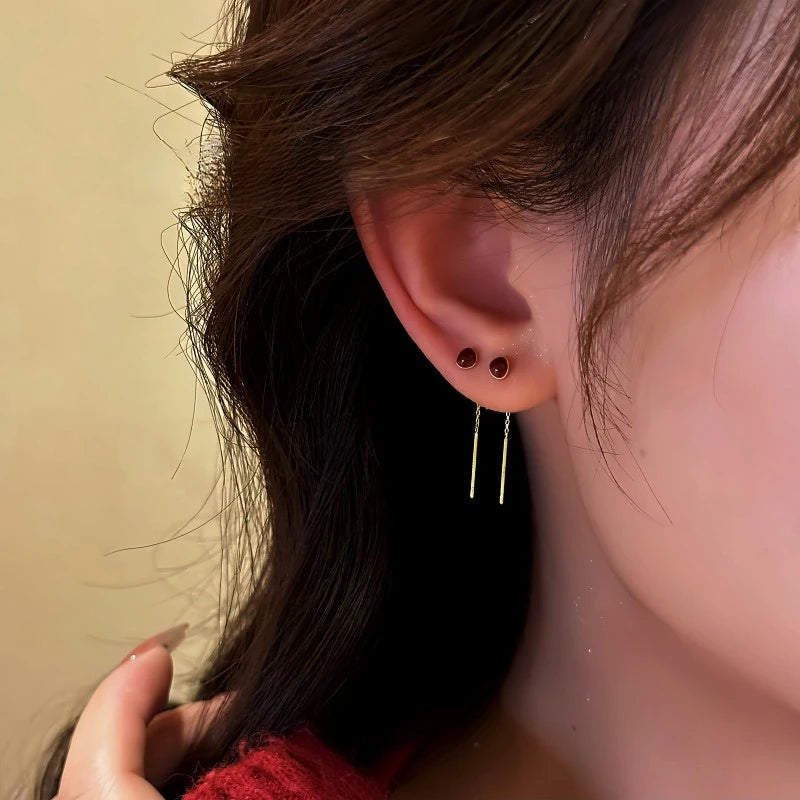 Model showcasing the dangle and style of the 14K Gold Plated Red Bean Threader Earrings