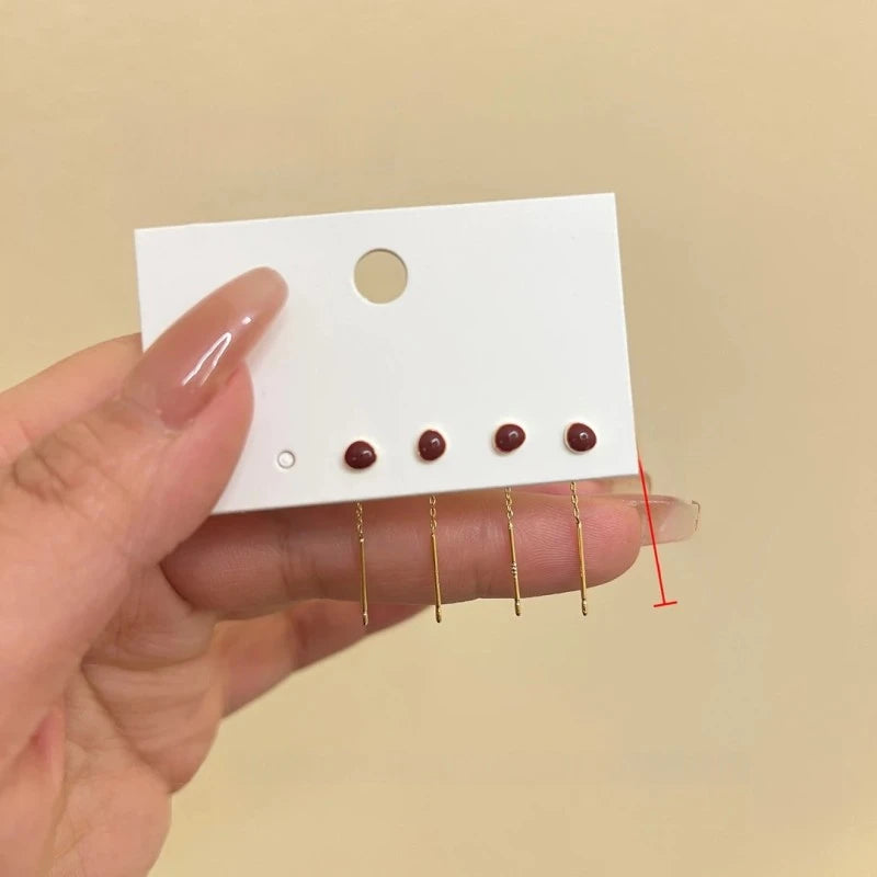 Angled view of the 14K Gold Plated Red Bean Threader Earrings