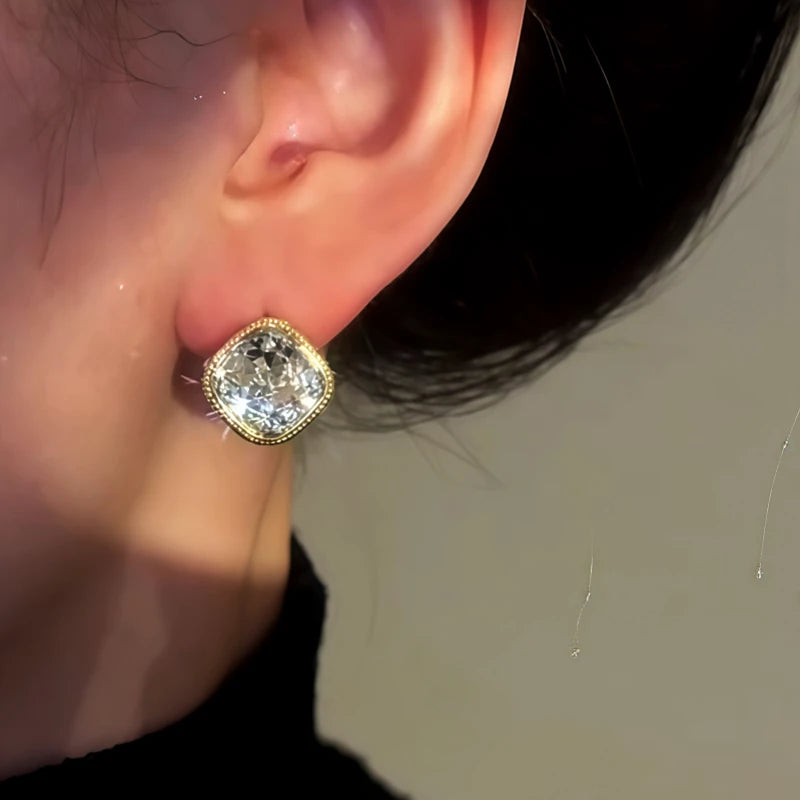 Close-up detail of the sparkling zircons and plating on the red drop earrings