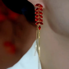 Close-up detail of the sparkling zircons and plating on the gold tassel earrings