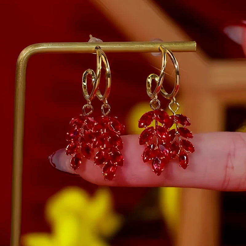 Angled view of the 14K Gold Plated Red Zircon Wheat Earrings