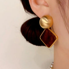 Model showcasing the dangle and style of the 14K Gold Plated Simple Square Earrings