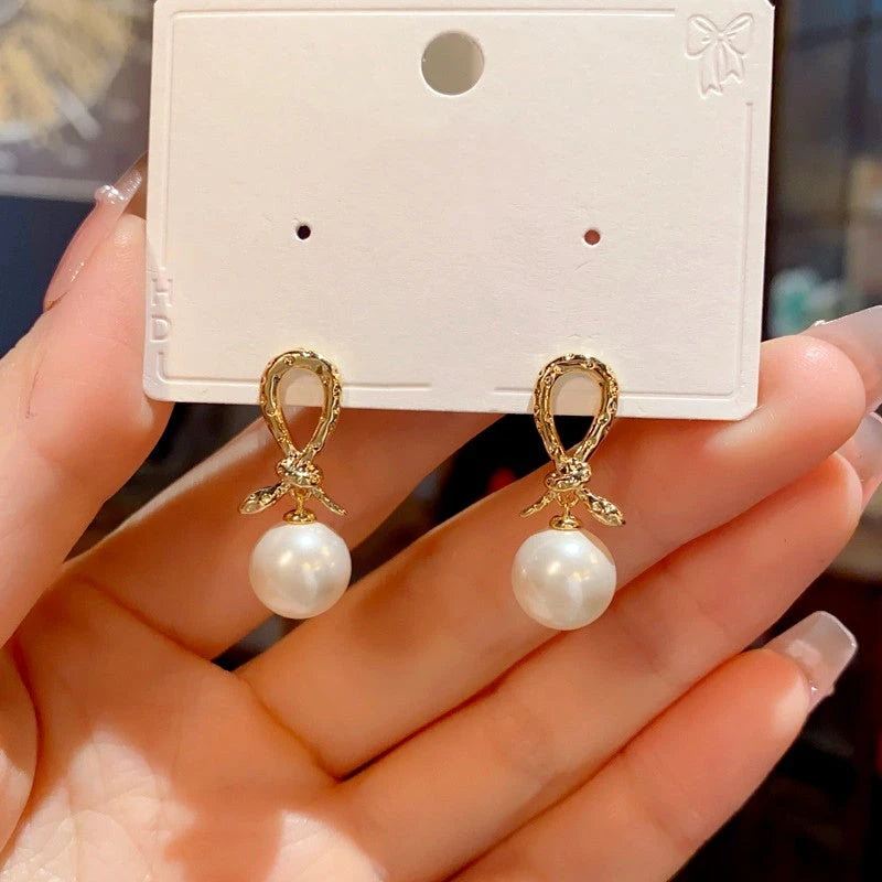 Close-up detail of the sparkling zircons and plating on the gold pearl earrings